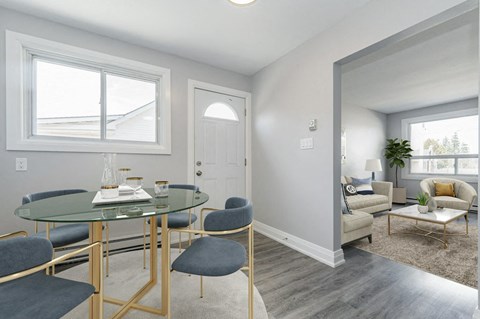 a dining room with a table and chairs and a living room